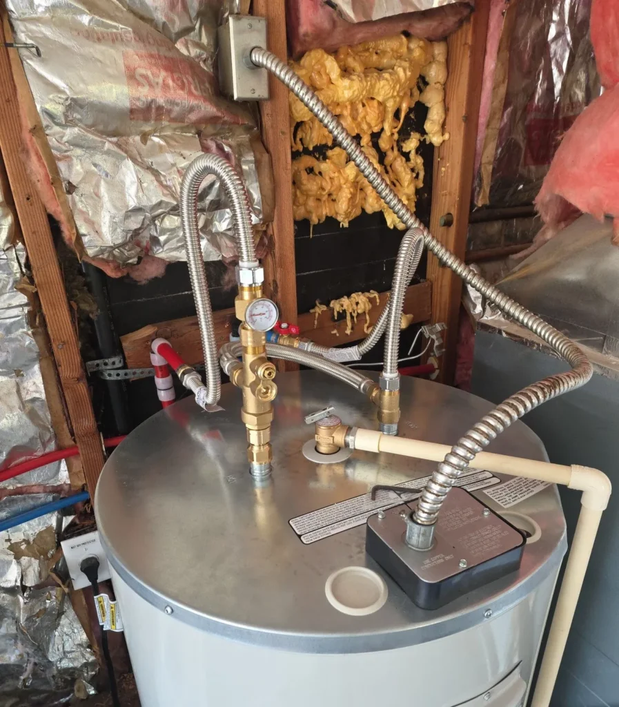 Close-up of a newly installed water heater's top connections